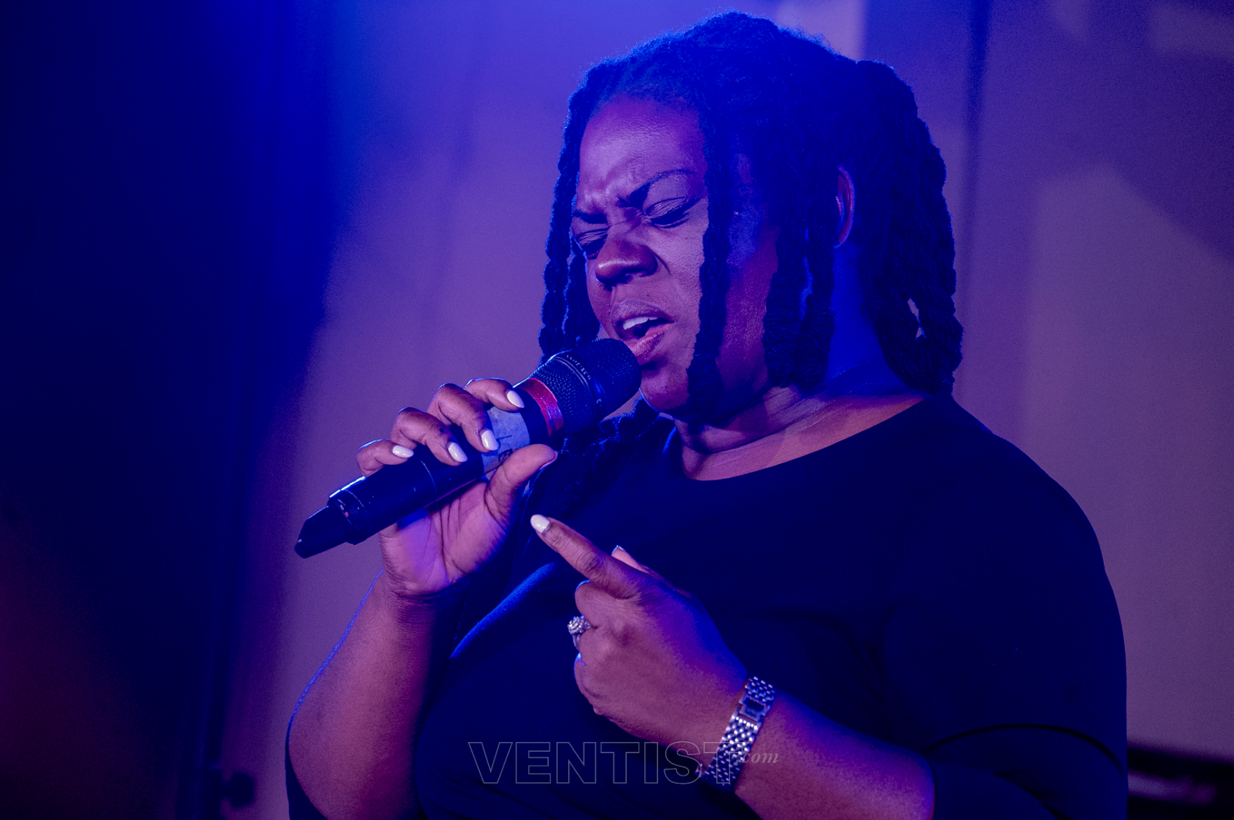 Vocalist singing under deep blue stage light at Beyond Time 2026
