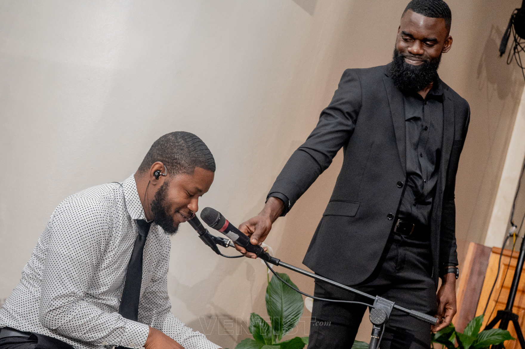 Worship leader holding the mic for a kneeling singer at Beyond Time 2026