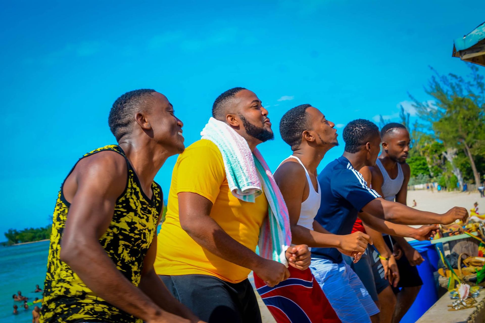 Group of young Christian men together at the beach in unity